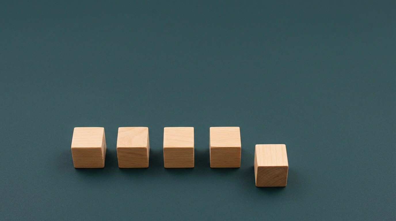 Five wooden blocks in a row, the last one pushed out of line